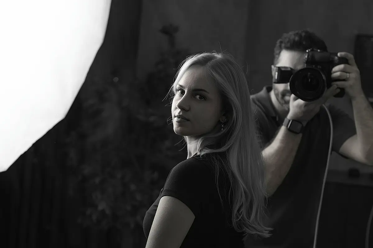 Shooting im Studio: Fotograf bei der Aufnahme eines Porträts
